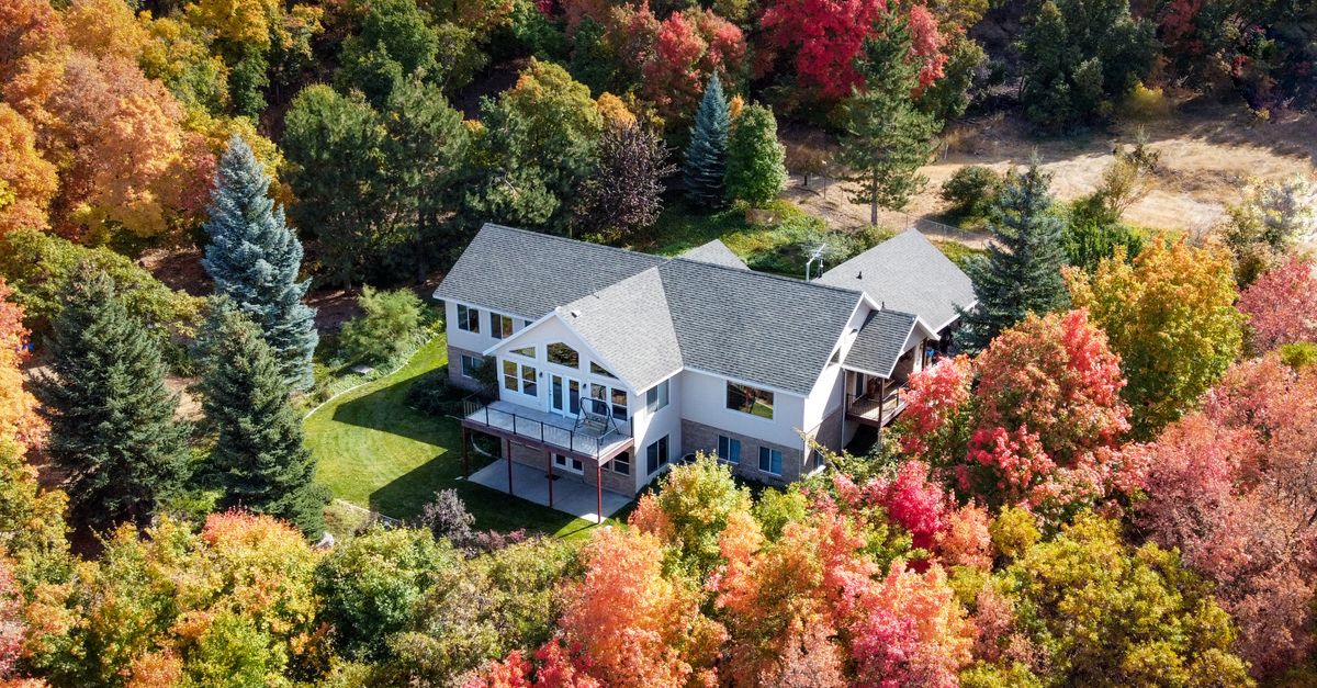 Charming suburban home surrounded by vibrant fall foliage in Woodland Hills, Utah.