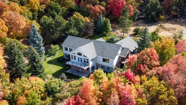 Charming suburban home surrounded by vibrant fall foliage in Woodland Hills, Utah.