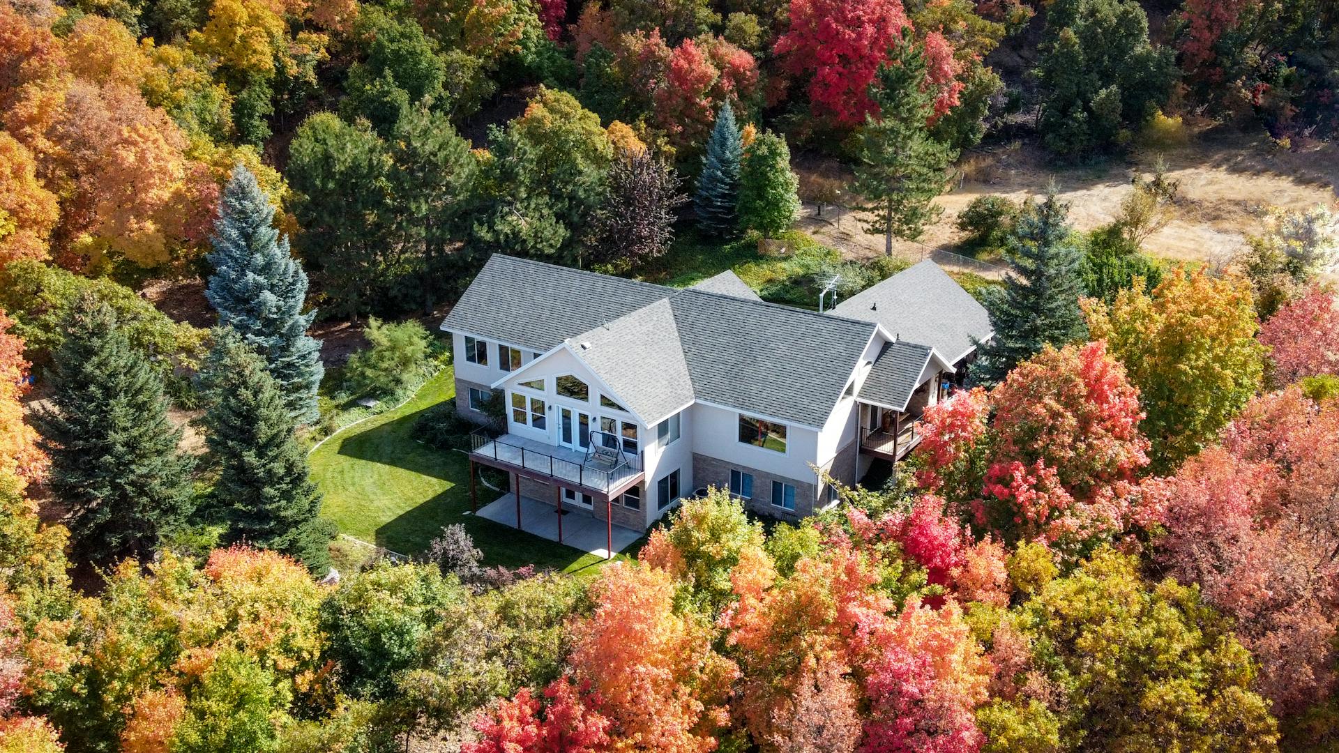 Charming suburban home surrounded by vibrant fall foliage in Woodland Hills, Utah.