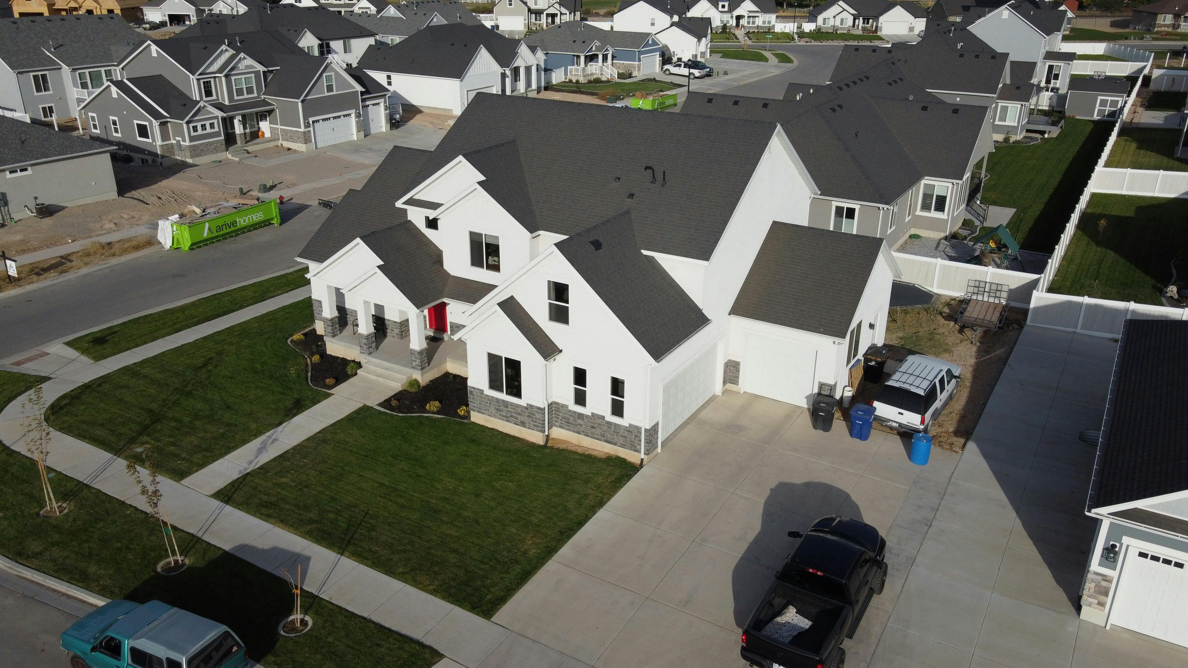 Aerial shot of a modern residential area in Spanish Fork, UT with white houses.