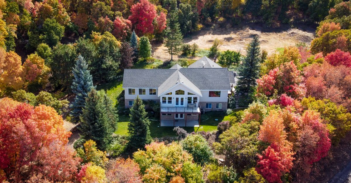 Charming house surrounded by colorful autumn trees in Spanish Fork, Utah.