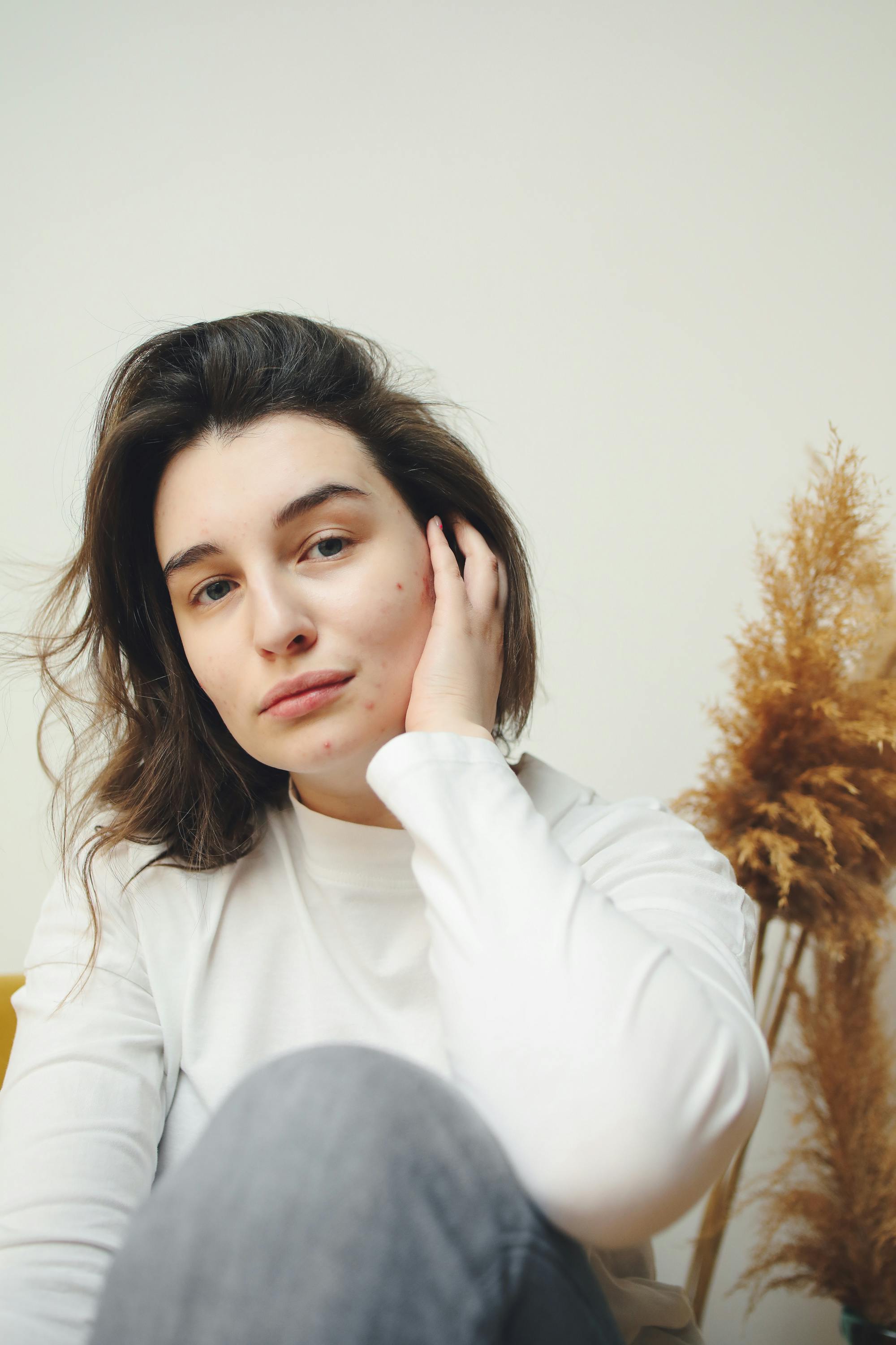 Free A Woman Touching Her Face Stock Photo