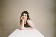 Woman in White Tank Top Sitting on Chair
