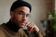 Man in Brown Sweater Wearing Black Knit Cap and Black Framed Eyeglasses