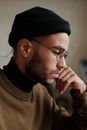 Man in Brown Sweater Wearing Black Knit Cap and Black Framed Eyeglasses