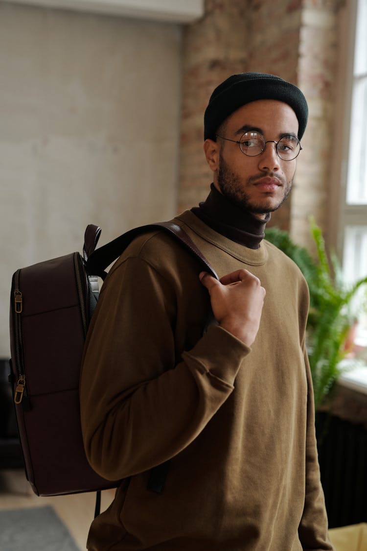 Man In Brown Coat And Black Cap