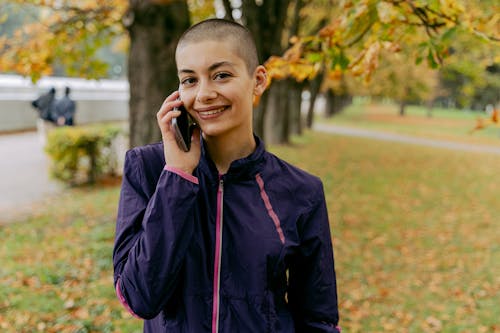Free Woman in Purple Jacket receives a Phone Call  Stock Photo