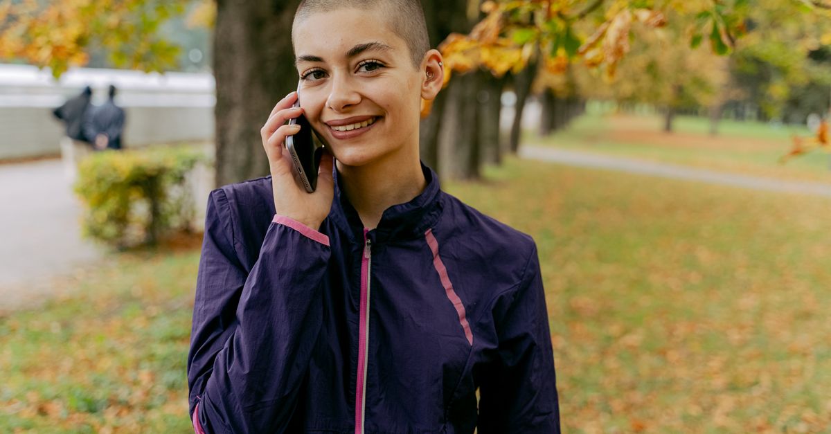 person walking in park without phone, looking relaxed
