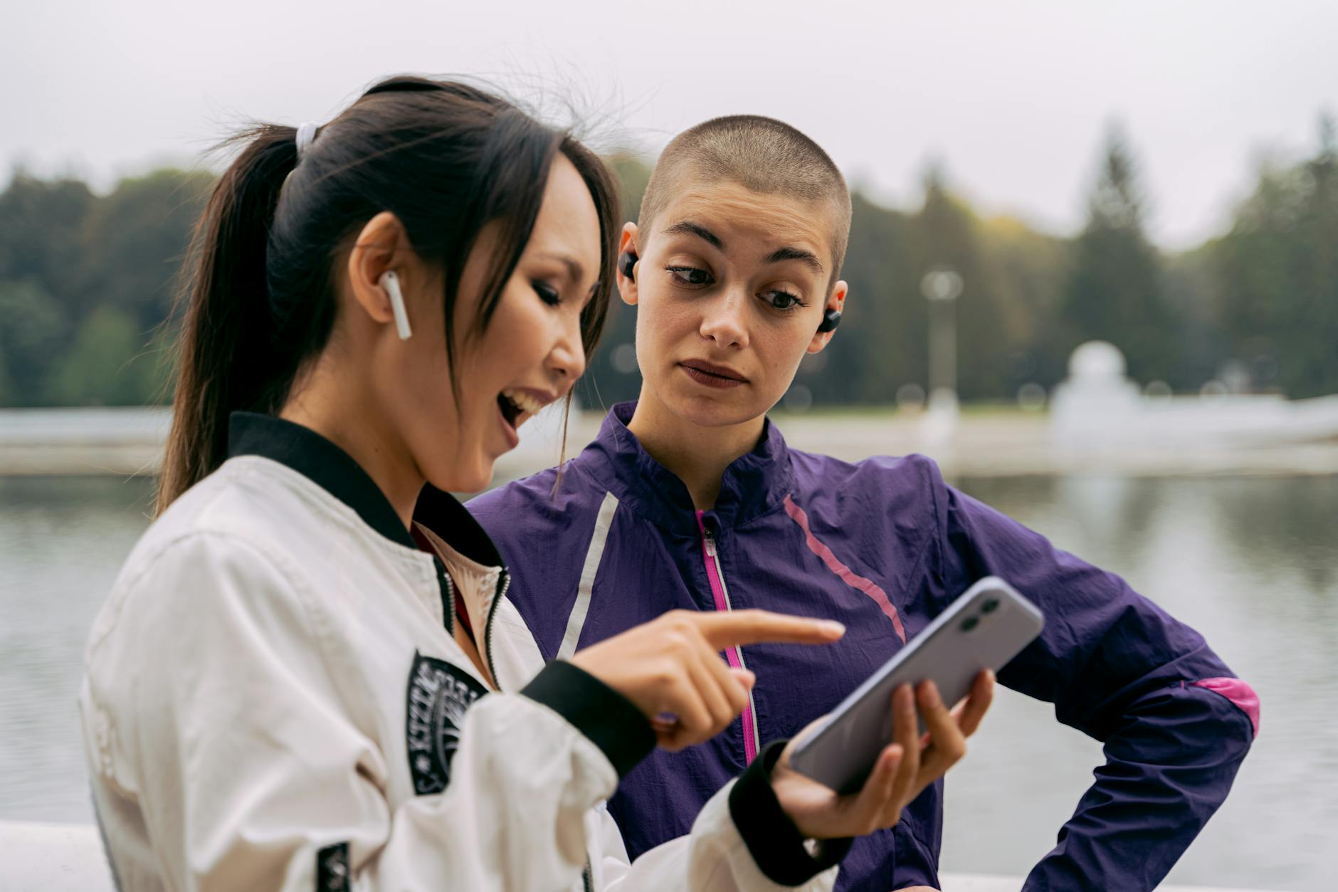 Woman in Purple Jacket looking at a Phone