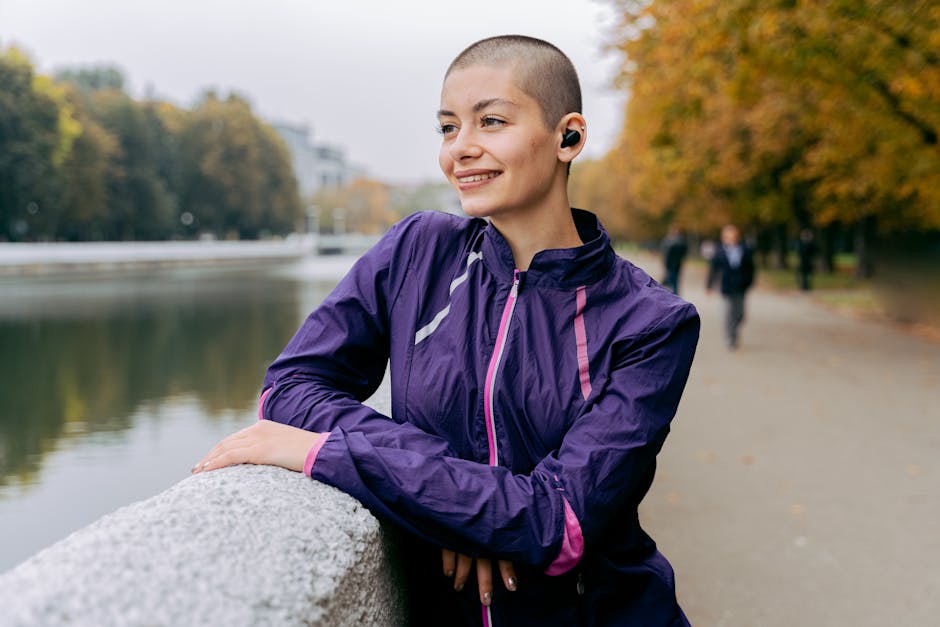 A person walking along a riverside trail with headphones on. Captured by Antoni Shkraba Studio