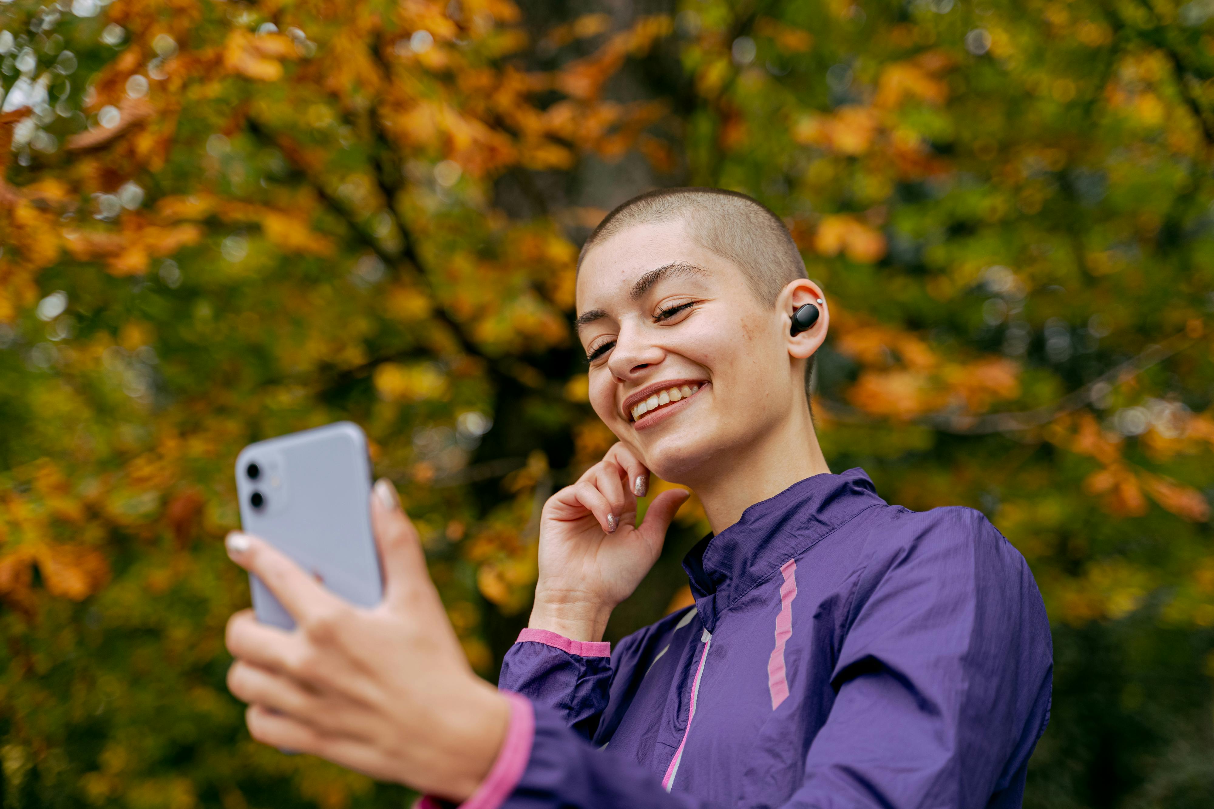 woman in purple jacket receives a phone call