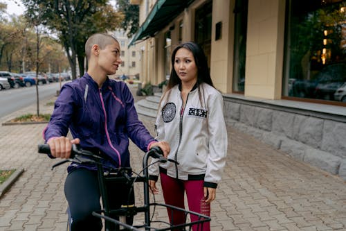 Woman Riding Bicycle Looking at a Friend