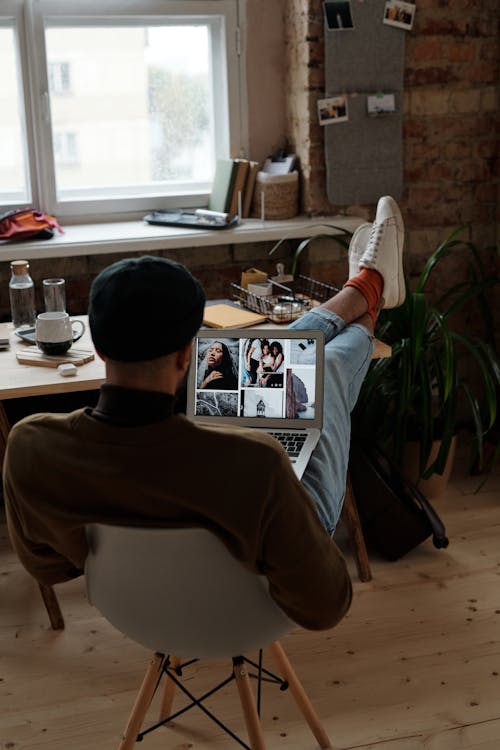 Man in White Crew Neck T-shirt Sitting on Chair