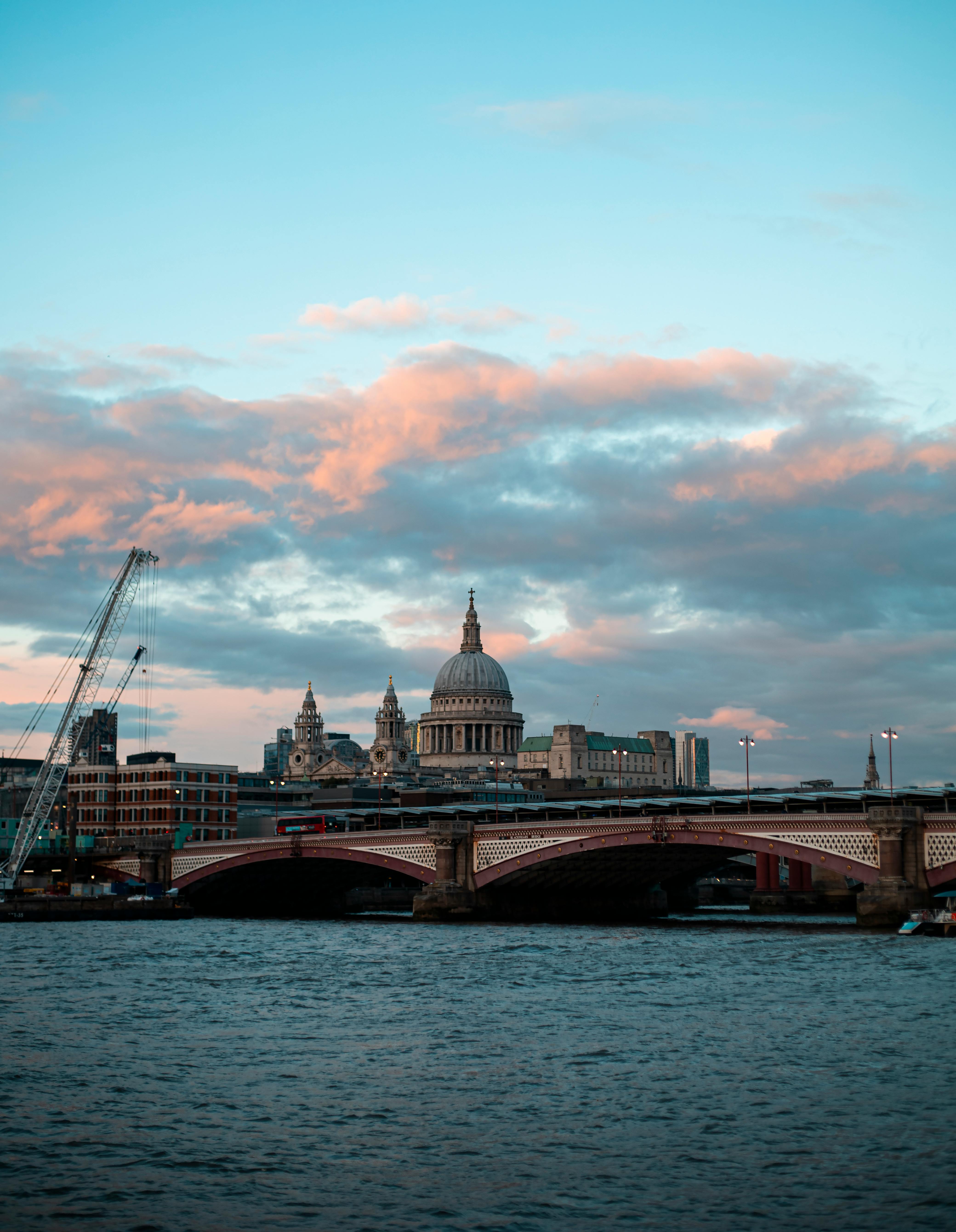 A breathtaking view of St Paul's Cathedral and Blackfriars Bridge at sunset, taken from the River Thames.