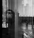 Black and white through window view of famous square with antique cathedral located on pavement reflected on glass in daytime