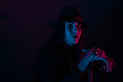 Free Person with Serious Face Sitting in the Dark  Stock Photo