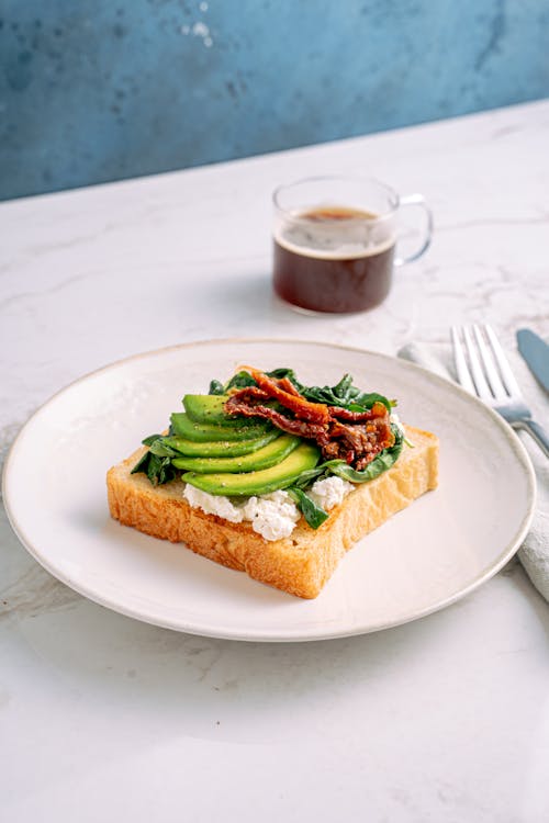 Free Toasted Bread with Avocado Slices on White Ceramic Plate Stock Photo