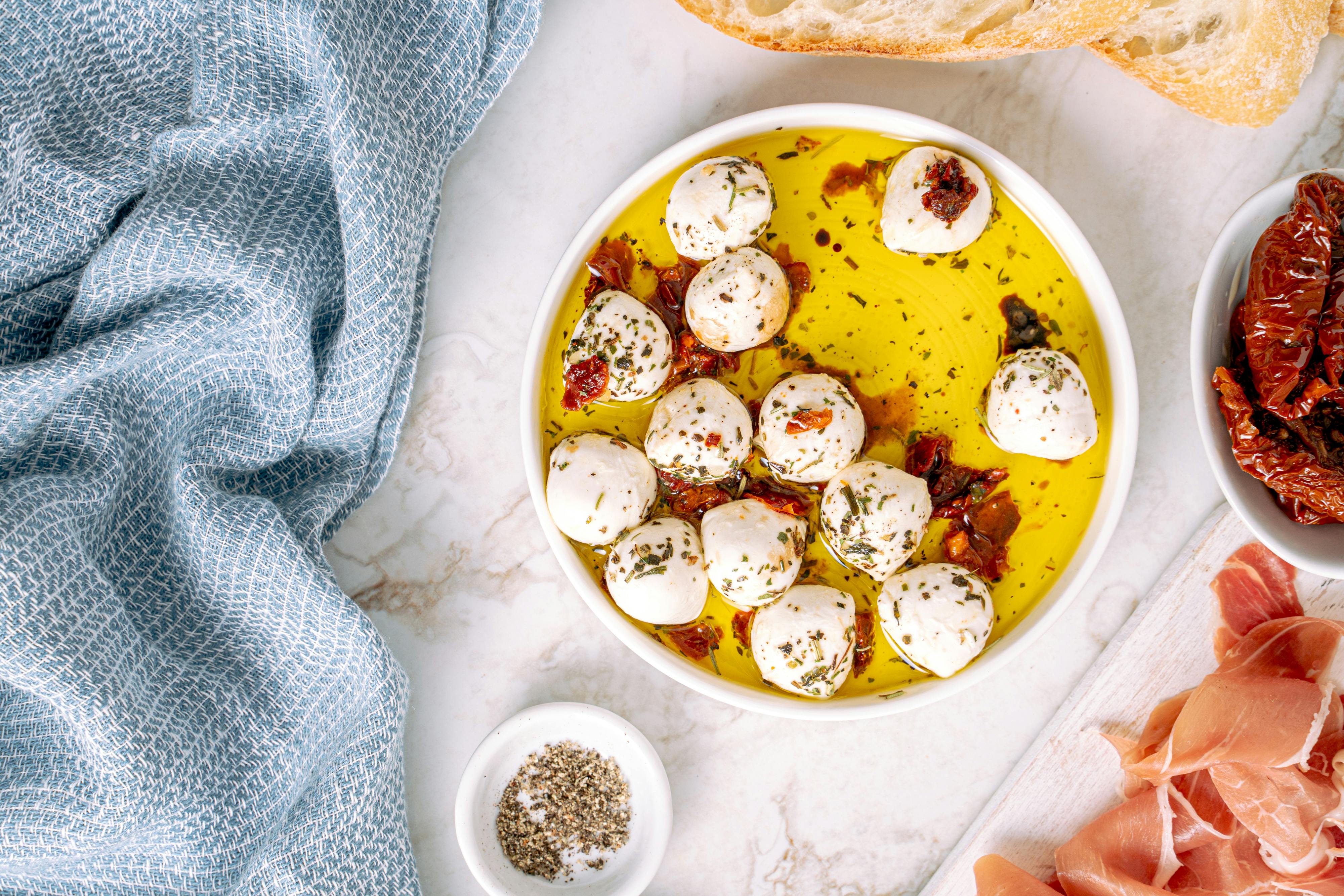 marinated mozzarella in white ceramic bowl