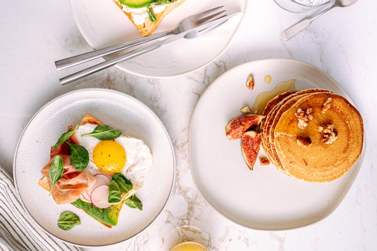 Pancakes Beside A Plate Of Toast 