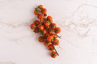 Red and Orange Fruits on White Surface