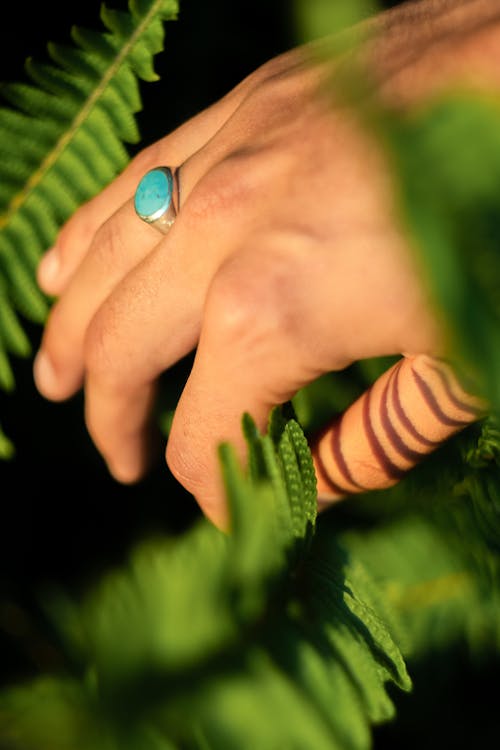 Person Wearing a Ring with Blue Stone 