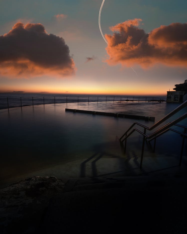 Swimming Pool By The Sea During Sunset