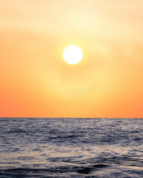 Captivating sunrise with orange hues over the ocean at Bronte Beach, NSW, Australia.