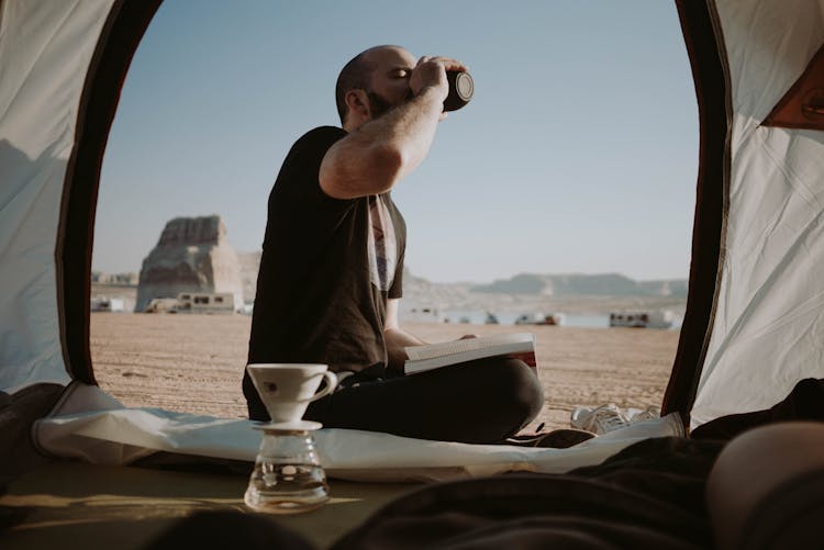 Man Drinking Coffee In Tent