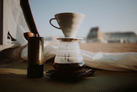 A serene outdoor scene of pour over coffee brewing inside a tent, perfect for camping enthusiasts.