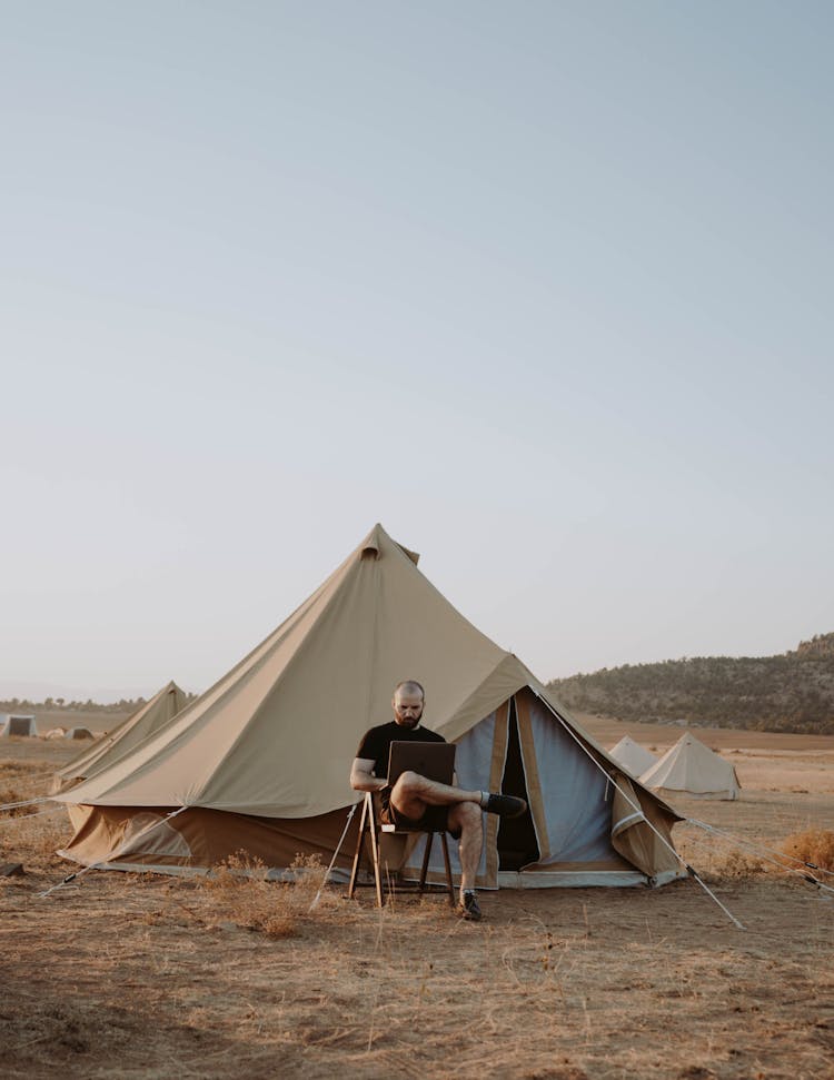 Man With Laptop Resting In Camping