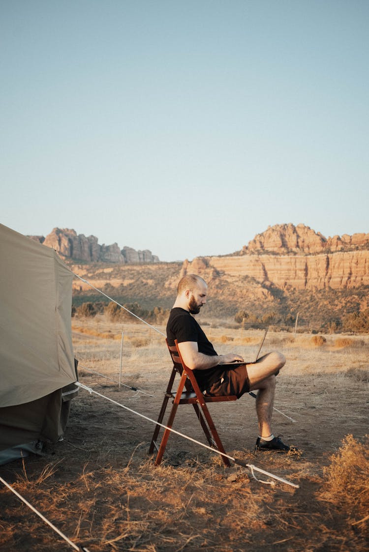 Man Working On Laptop In Nature