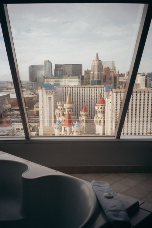 Free Interior of contemporary bathroom with large glass windows against business district with high rise buildings Stock Photo