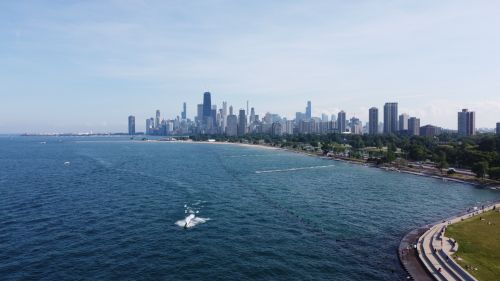 Free Breathtaking aerial view of Chicago skyline overlooking Lake Michigan with clear blue skies. Stock Photo