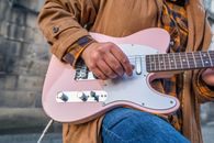 Person Wearing a Jacket Playing Guitar