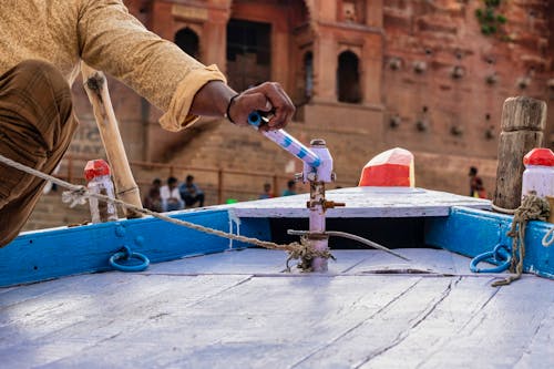 Person Holding the Tiller of a Boat
