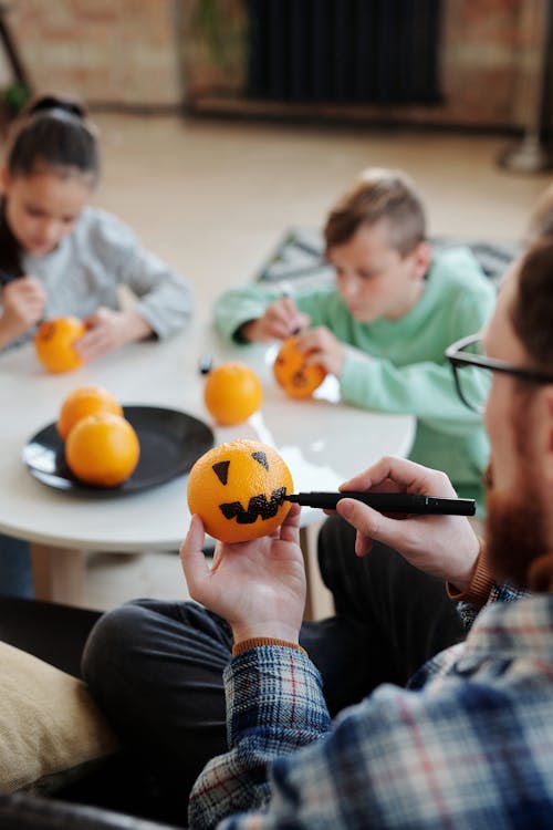 A Family Designing Orange Fruits