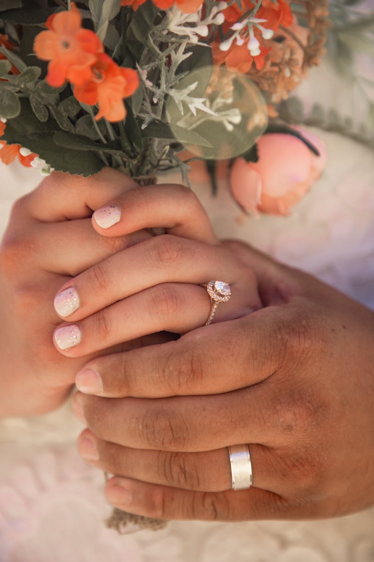 Close-up Photo Of A Couple With Wedding Rings 