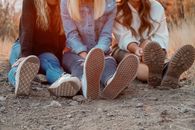 2 Women Sitting on Ground