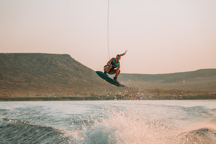 Woman Riding A Wakeboard In The Air