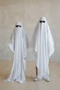 Two Persons Wearing a White Halloween Costume