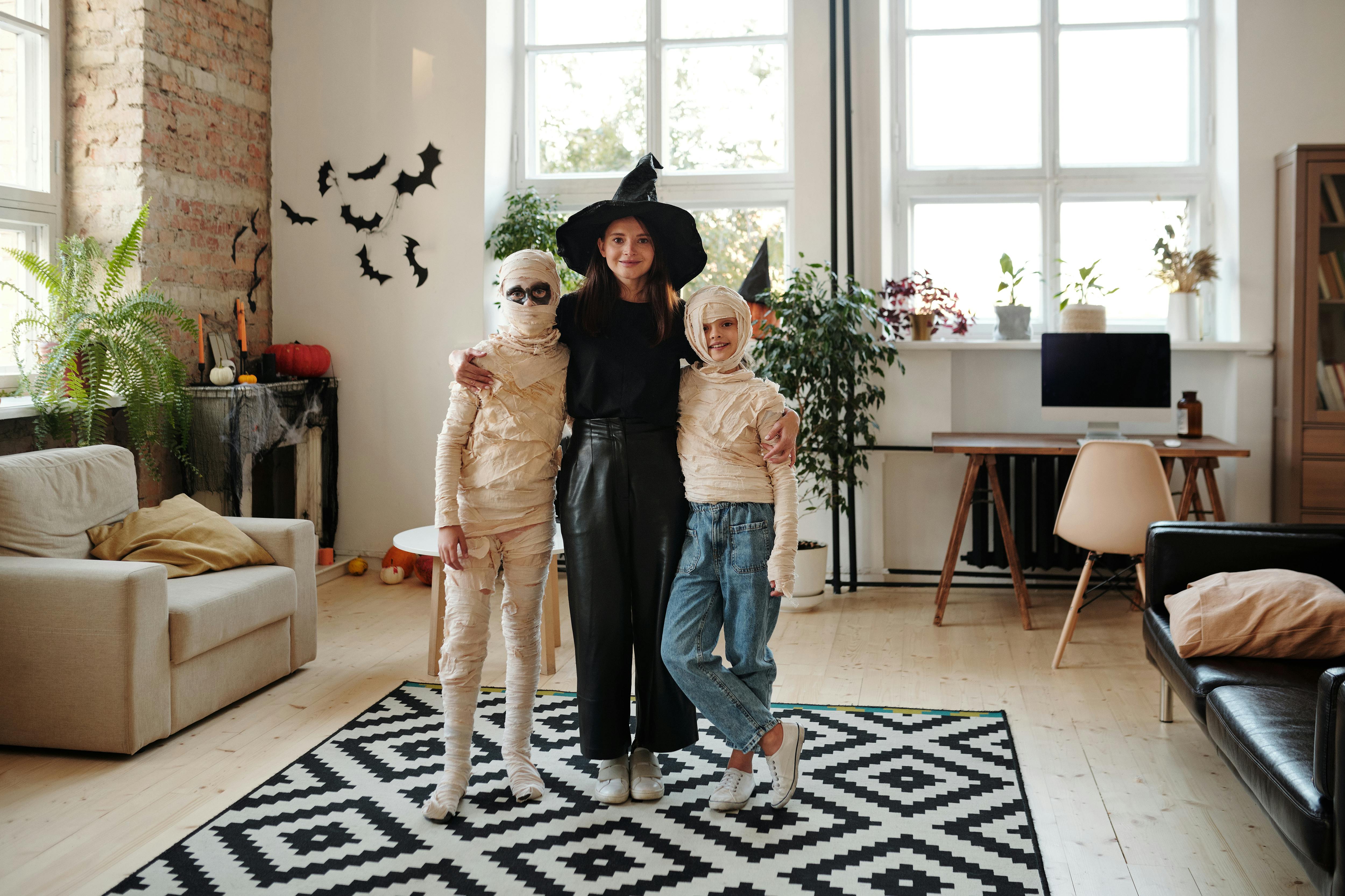 a family wearing halloween costumes while smiling