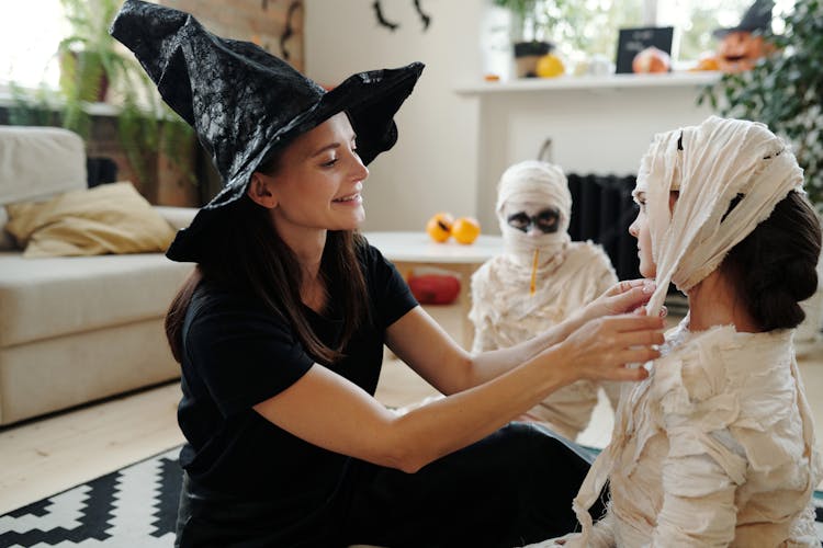 Mother Dressing Up Her Kids With Mummy Costume