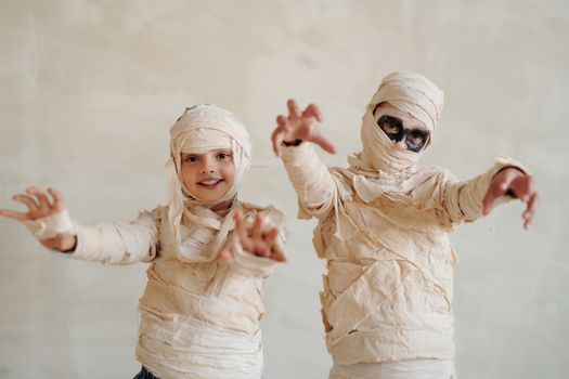 Two Kids Wearing a Mummy Costume