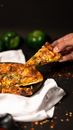 Person Holding Pizza on White Ceramic Plate