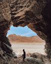 Silhouette of Person Standing on Rock Formation