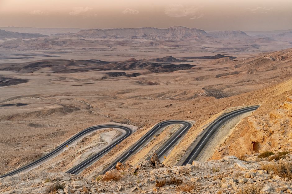 Egged bus traveling on a road through the desert landscape of Israel