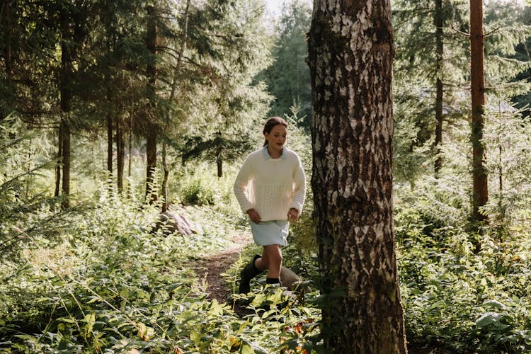 A Woman Running In The Forest 