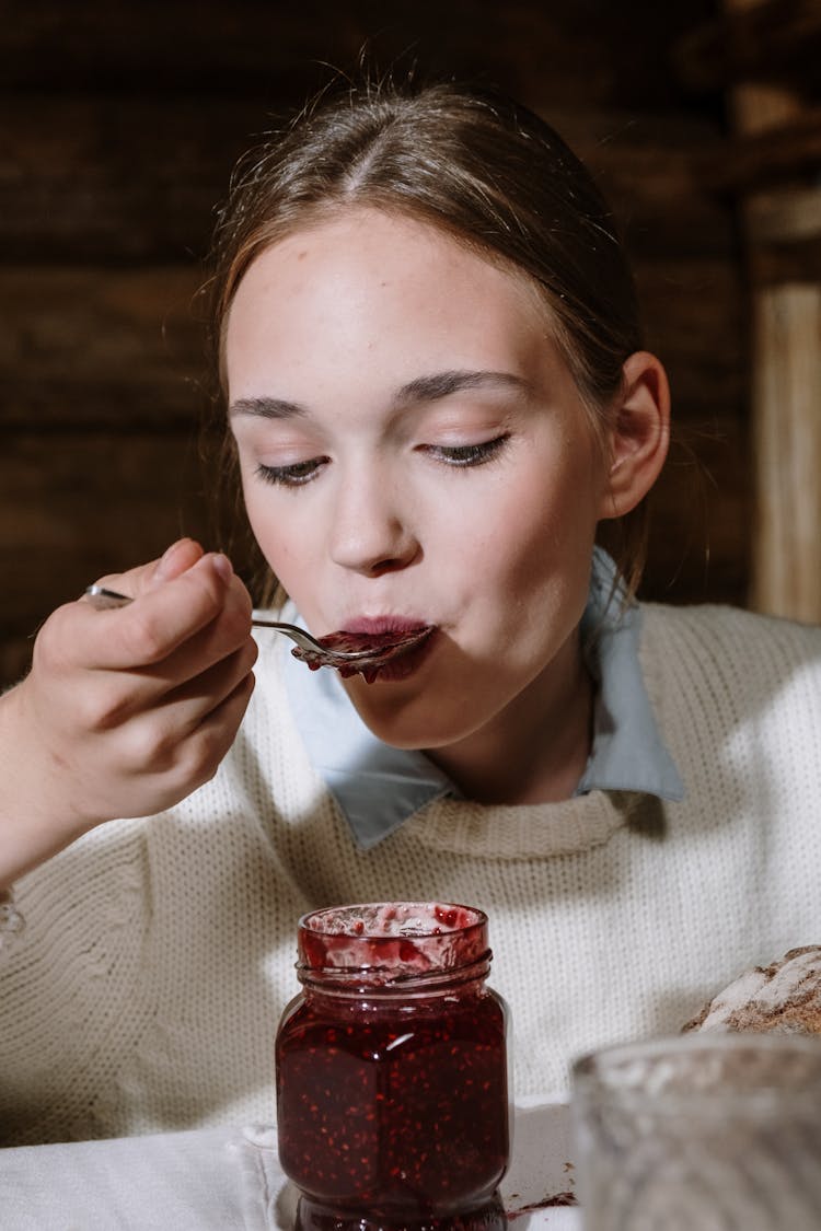 A Woman Eating Jam