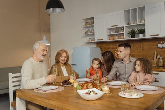 A multi-generational family enjoying a dinner together in a warm, cozy kitchen setting.