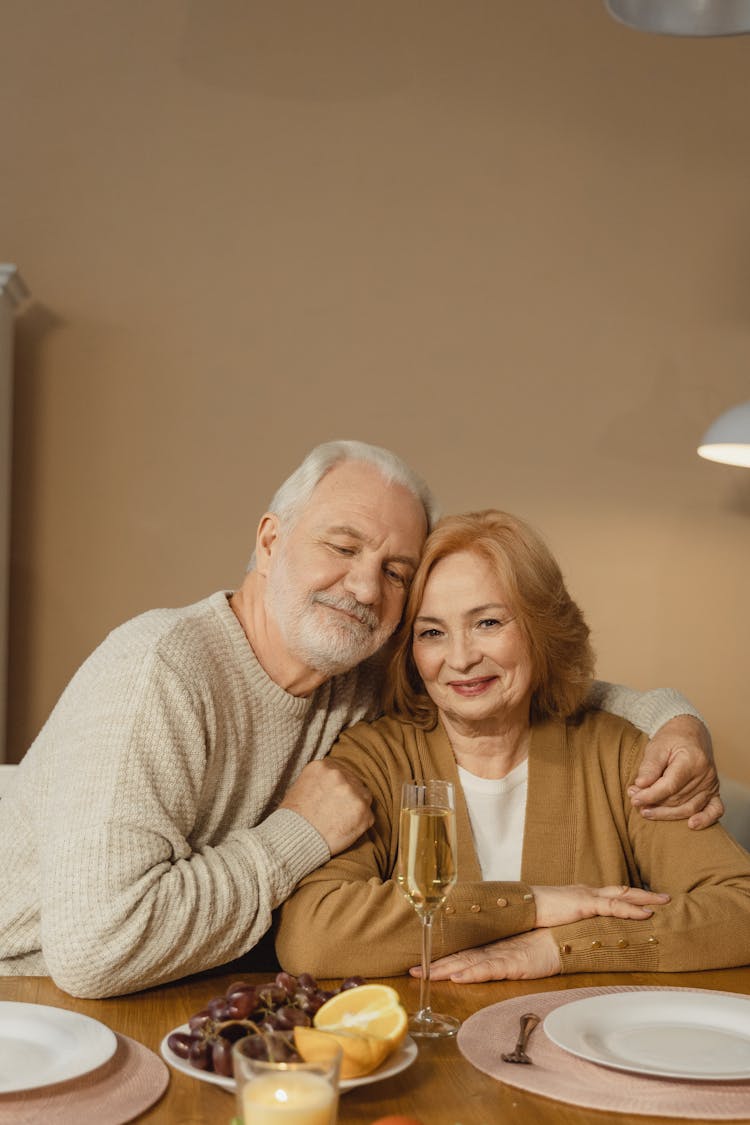 A Man Embracing A Woman At The Table 